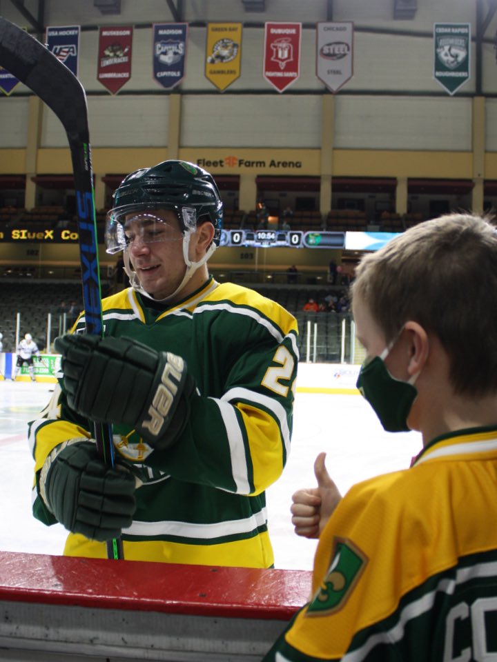 Hockey Player and Child Giving a Thumbs Up